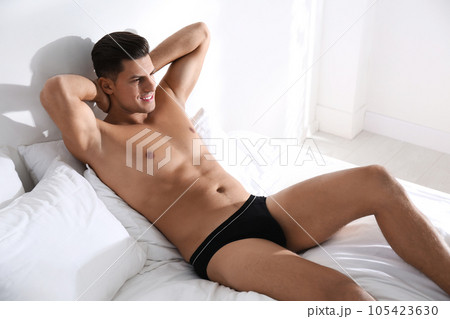 Handsome man in black underwear on bed indoors - Stock Photo [105423630] -  PIXTA