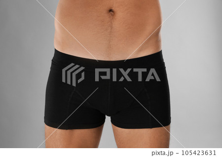 Man in black underwear on light grey background, closeup Man in black underwear on light grey background, closeup 105423631