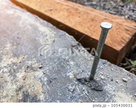 Concrete nails that are driven into the cement floor to tie ropes that will be used to find the width and length of the area 105430031