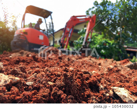 Soil close up blurred backhoe to renovate the site in preparation for pouring the concrete slab 105430032