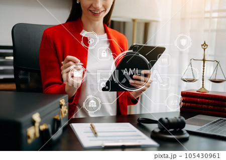 AML Anti Money Laundering Financial Bank Business Concept. judge in a courtroom using laptop and tablet with AML anti money laundering icon on virtual screen. . AML Anti Money Laundering Financial Bank Business Concept. judge in a courtroom using laptop and tablet with AML anti money laundering icon on virtual screen. . 105430961
