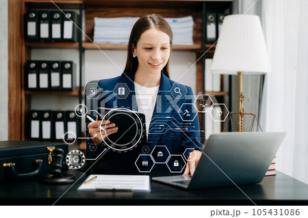 Beautiful Caucasian woman lawyer working and gavel, tablet, laptop in front, Advice justice and law concept. 105431086