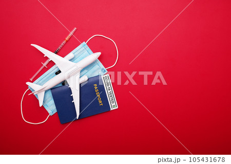 Syringe, toy plane, medical mask and passport with Covid-19 test Syringe, toy plane, medical mask and passport with Covid-19 test 105431678