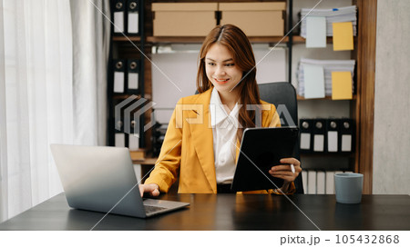 Confident business expert attractive smiling young woman holding digital tablet on desk in creative office. Confident business expert attractive smiling young woman holding digital tablet on desk in creative office. 105432868