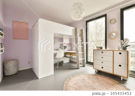 a room with purple walls, white furniture and a pink rug on the floor in front of a large window a room with purple walls, white furniture and a pink rug on the floor in front of a large window 105435452