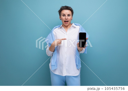 stylish young brunette woman with short haircut demonstrates smartphone mockup stylish young brunette woman with short haircut demonstrates smartphone mockup 105435756