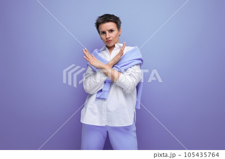 portrait of a young woman with a short haircut in a stylish casual look with a gesture of portrait of a young woman with a short haircut in a stylish casual look with a gesture of 105435764