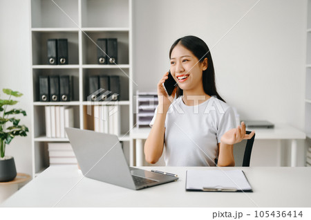 Successful Asian Businesswoman Analyzing Finance on Tablet and Laptop at Office Desk tax, report, accounting, statistics, and analytical research concept. Successful Asian Businesswoman Analyzing Finance on Tablet and Laptop at Office Desk tax, report, accounting, statistics, and analytical research concept. 105436414