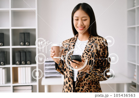 Woman hand using a laptop, smartphone and tablet and writing notebook at the office of her business online shopping. In home with virtual icon . Woman hand using a laptop, smartphone and tablet and writing notebook at the office of her business online shopping. In home with virtual icon . 105436563
