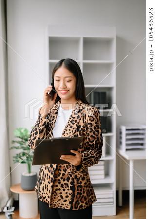 Happy asian business woman have the joy of talking on the smartphone, tablet and laptopon the office Happy asian business woman have the joy of talking on the smartphone, tablet and laptopon the office 105436623