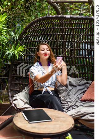 Young beautiful woman looking at pocket mirror prepearing herself for job interview 105437035
