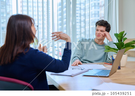 School psychologist supporting guy student, sitting in office of educational building 105439251