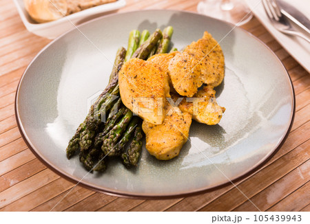 Dietary meal rich in protein. Stir fried chicken breast and green asparagus 105439943