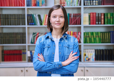 Portrait of confident female college student inside library in educational building 105440777