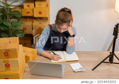 Young woman working online e-commerce shopping at her store stressed with sales. Young woman working online e-commerce shopping at her store stressed with sales. 105443043