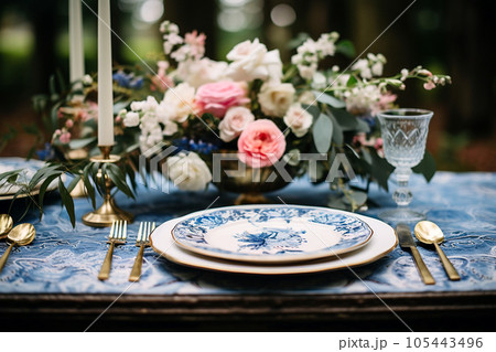 Flower table decorations for wedding dinner. Wedding table set for holiday, event, party, wedding reception in outdoor restaurant. Pink and blue with gold wedding table setting. AI generated 105443496