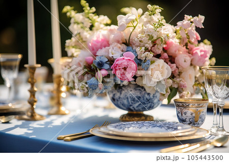 Flower table decorations for wedding dinner. Wedding table set for holiday, event, party, wedding reception in outdoor restaurant. Pink and blue with gold wedding table setting. AI generated 105443500