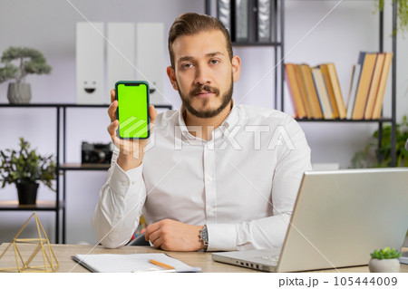 Developer business man hold smartphone with green screen chroma key recommend application sale offer 105444009