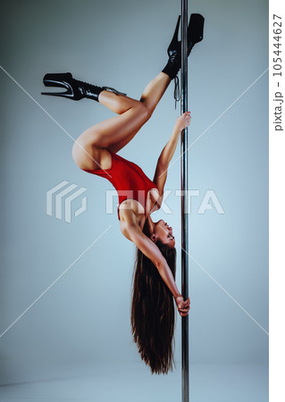 Woman pole dancing 105444627
