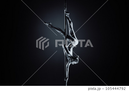 Young woman pole dancing 105444792