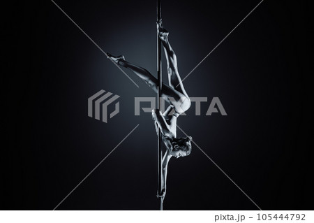 Young woman pole dancing Young woman pole dancing 105444792