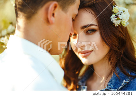 Beautiful loving couple in blooming gardens. Wedding concept. Great sunset light. Lovely newlyweds. Beautiful loving couple in blooming gardens. Wedding concept. Great sunset light. Lovely newlyweds. 105444881