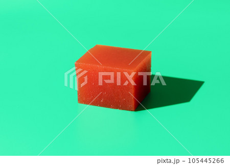 Quince marmalade cube isolated on a green background Quince marmalade cube isolated on a green background 105445266