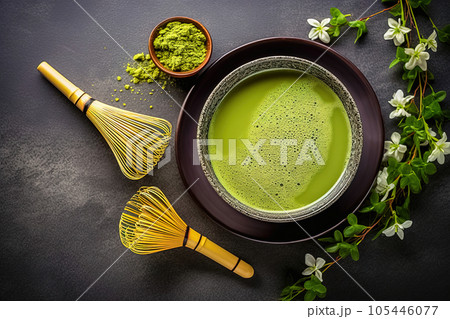 Matcha green tea powder and whisk, on a black background with place for text. 105446077