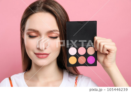 Beauty blogger with eyeshadow palette on pink background Beauty blogger with eyeshadow palette on pink background 105446239