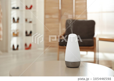 Aroma oil diffuser on table indoors, space for text. Air freshener Aroma oil diffuser on table indoors, space for text. Air freshener 105446598