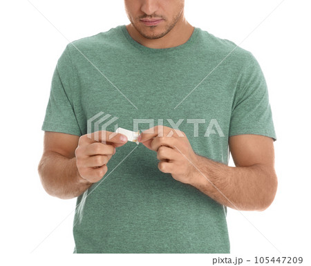 Man with sticking plaster on white background, closeup 105447209