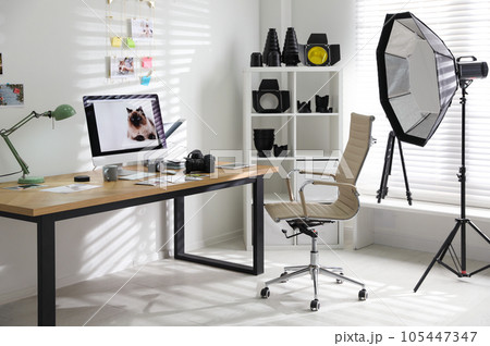 Photographer's workplace with professional camera and computer in office Photographer's workplace with professional camera and computer in office 105447347