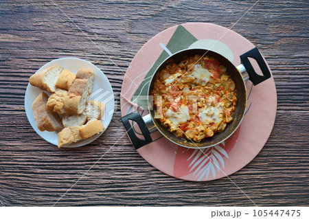 Turkish Menemen omelet in a frying pan. . 105447475