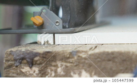 smooth movements with the saw along the marked cutting line on the chipboard. 105447599