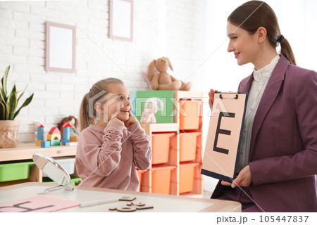 Speech therapist working with little girl in office Speech therapist working with little girl in office 105447837
