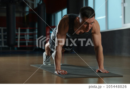 Man doing plank exercise in modern gym 105448026
