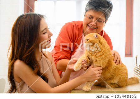 A senior with her daughter is depicted in a happy portrait at their home 105448155