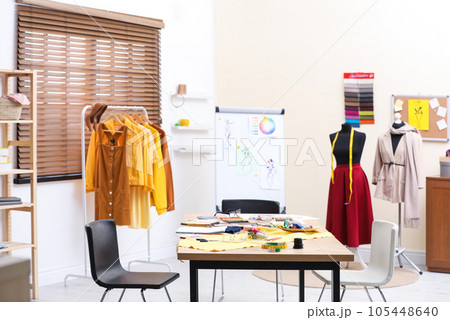 Fashion designer's workplace in studio. Creating new clothes Fashion designer's workplace in studio. Creating new clothes 105448640