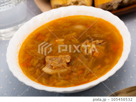 Russian-style cabbage soup Shchi of pork broth with boiled vegetables 105450532