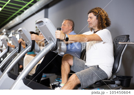 Man doing cardio training on stationary bike in gym 105450604