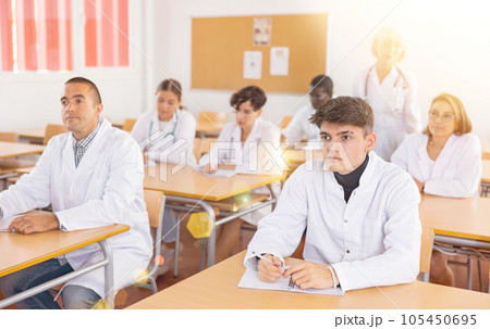 Group of doctor trainees listening to lecture during refresher course Group of doctor trainees listening to lecture during refresher course 105450695