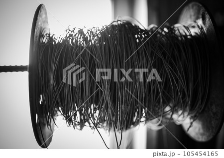 Silhouette spool of thick wire on a spindle. Silhouette spool of thick wire on a spindle. 105454165