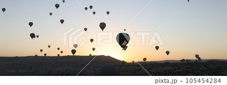 Many hot air balloons flying in sunset sky at Cappadocia, Turkey. Many hot air balloons flying in sunset sky at Cappadocia, Turkey. 105454284