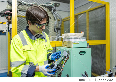Male technician engineer checking parts automation robotics at industrial modern factory. 105454782