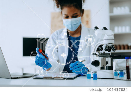 Coronavirus COVID 19 medical test vaccine research and development concept. Scientist in laboratory study and analyze scientific sample of Coronavirus antibody with Vr icon 105457824