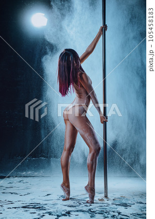 Young woman pole dancing 105458183