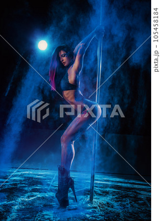 Young woman pole dancing 105458184
