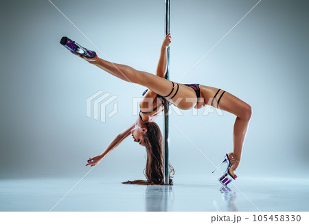 Woman pole dancing 105458330