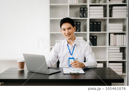 Businessman using tablet and laptop for doing math finance on an office desk, tax, report, accounting, statistics, and analytical research concept in office 105461076