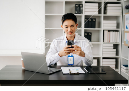 Businessman using tablet and laptop for doing math finance on an office desk, tax, report, accounting, statistics, and analytical research concept in office 105461117